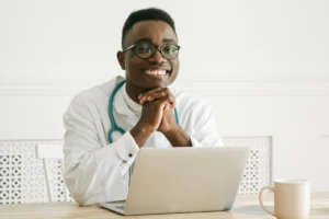 A virtual medical administrative assistant working on a computer, managing patient schedules, and verifying insurance claims remotely for a healthcare practice.