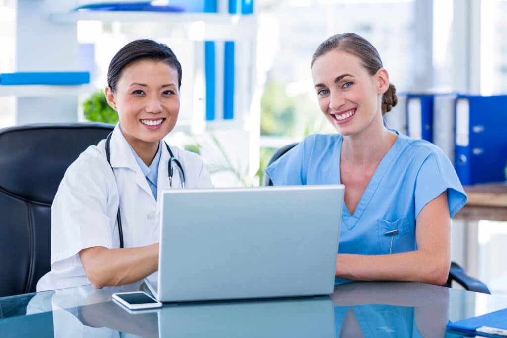 clinical medical assistant vs medical assistant two woman in front of laptop