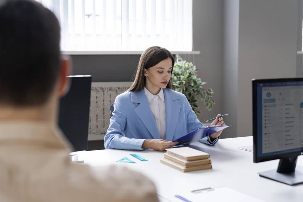 top 10 essential duties of a medical receptionist woman sitting in front of desk
