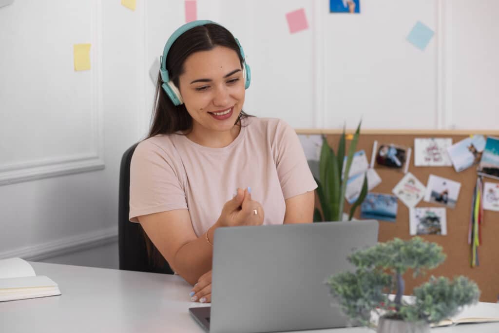 virtual assistant skills woman in front of laptop wearing headphone
