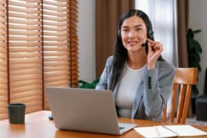 what is a virtual assistant wearing headphone in front of laptop