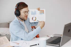 man holding a paper with statistics