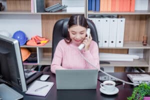 40 virtual assistant tasks woman in a call in front of laptop