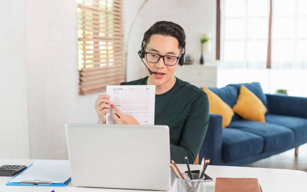 how much does a virtual assistant cost man pointing pen to a paper