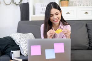 how much does a virtual assistant cost woman holding a credit card