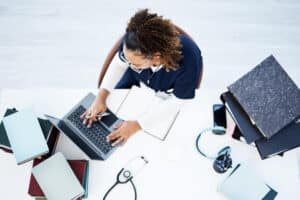 medical scribe role key responsibilities explained woman using laptop