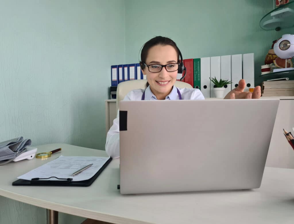 what is a virtual medical scribe doctor in front of laptop