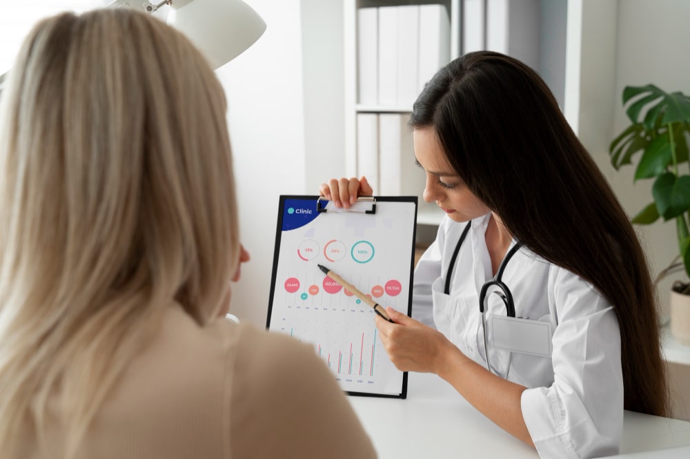 Doctor explains chart data to patient during consultation.