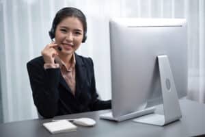 customer support virtual assistant woman wearing and holding headset microphone
