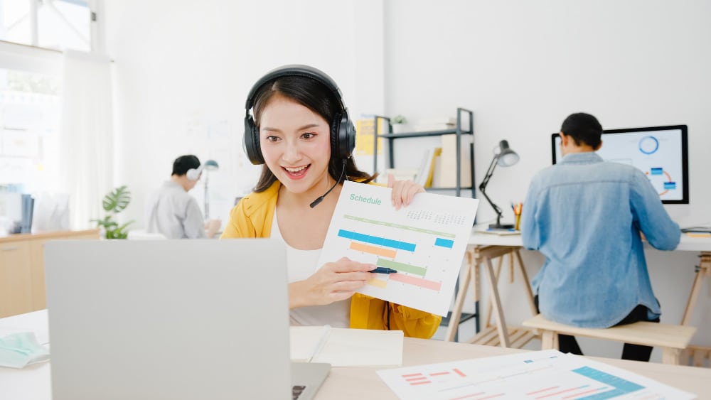 woman holding a paper with different color of progress bar