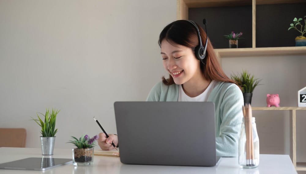 woman smiling while writing