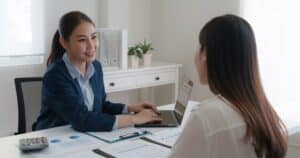 Smiling businesswoman discussing financial reports with a client