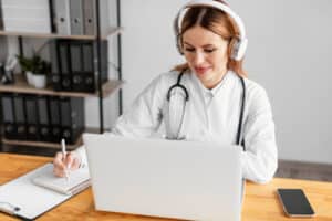 best remote medical scribe companies Female doctor with stethoscope wearing headphones