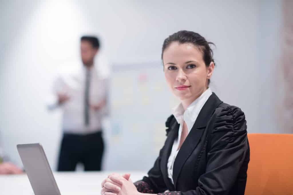 how to become a prior authorization specialist Confident businesswoman in formal attire sitting