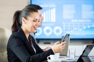 virtual medical billing solutions seated at a conference table with a tablet
