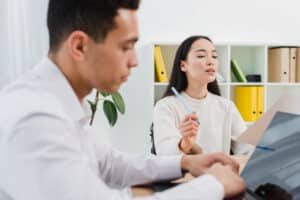 what do medical receptionist do Two young professionals working together in an office
