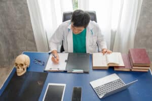 what is a medical scribe Medical student or doctor studying at desk