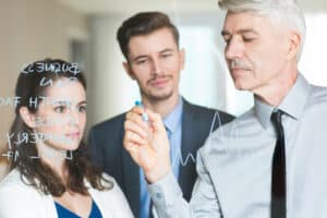 what is a scribe in healthcare Business team brainstorming strategy and writing growth plans on glass board