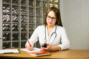 what is an er scribe A female healthcare professional