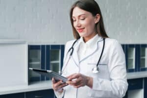 A doctor using a tablet reflects Future Trends in Virtual Medical Assistant Services