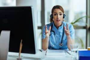 A nurse leads a video session, showing how virtual assistant onboarding in healthcare is streamlined with remote tools.