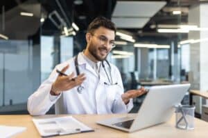 virtual medical assistant for startups Male doctor with stethoscope conducting online consultation