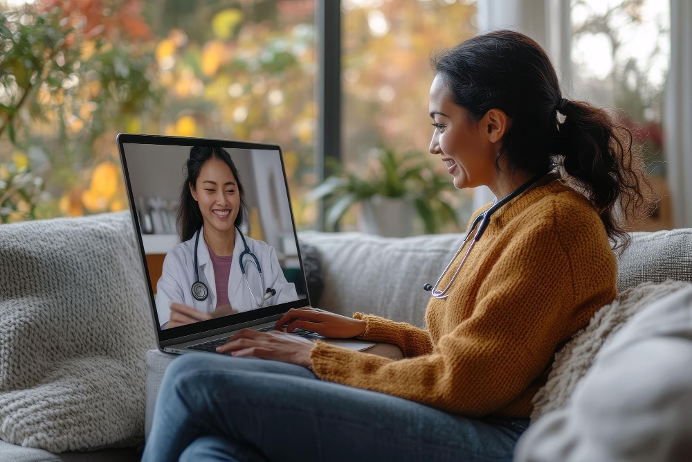 virtual patient care coordinator Smiling woman using laptop for virtual healthcare consultation