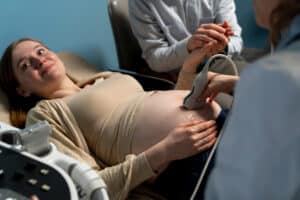 A pregnant woman gets an ultrasound, showing the importance of maternity obstetrical care medical billing.