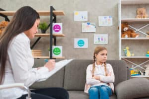 A therapist assesses a child’s behavior, as noted in the Speech Therapy Billing Manual