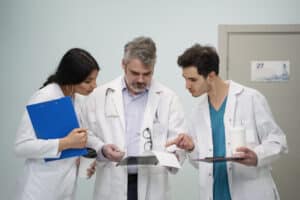 Doctors collaborating on notes with support from Solutions Medical Scribes