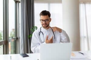 Young,Doctor,Speaks,With,Patient,Using,Laptop,Online,Video,Webinar