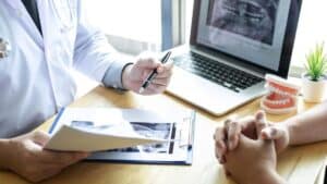 dental recall workflows that reactivate overdue patients, doctor and patient talking