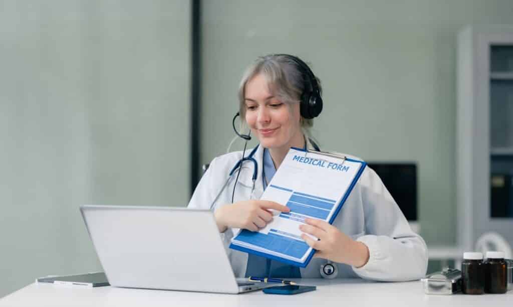 Pre-visit education and follow-up workflows for specialty practices, doctor conducting a video consultation to diagnose and prescribe treatment
