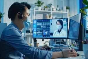 remote patient monitoring onboarding workflows for first-month retention male receptionist doing meeting through online