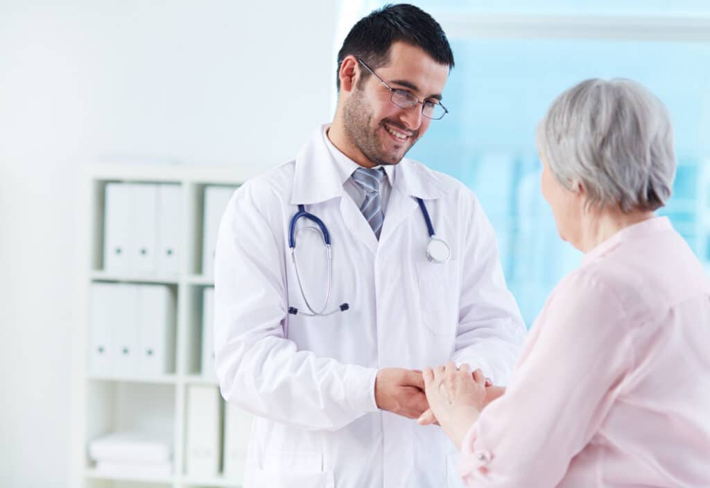 Doctor supporting a patient to build patient trust before first appointment at a medical clinic.