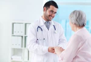 Doctor supporting a patient to build patient trust before first appointment at a medical clinic.