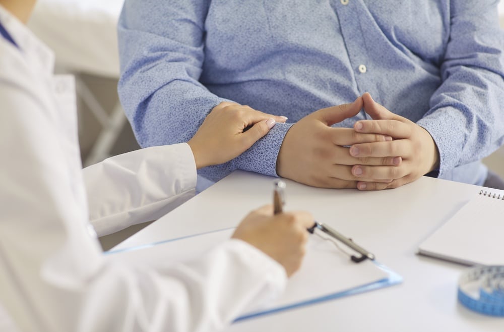 Doctor explaining obesity treatment during patient consultation with clinic callback system support