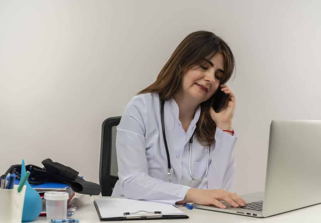 Doctor having a phone call at a medical clinic while providing medical customer service support to patients.