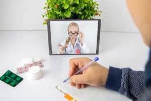 Man communicating with a doctor via video call on a tablet for medical consultation