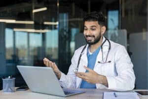 Doctor conducting a virtual consultation to support remote patient monitoring enrollment.