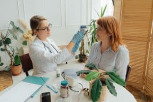 Healthcare professional assessing a patient while supporting specialty referral queue triage.