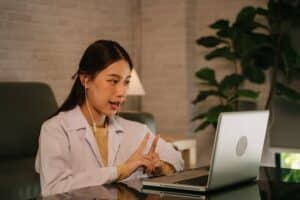 Healthcare professional clarifying a patient’s needs through bilingual specialty intake before scheduling.
