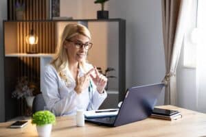 Healthcare professional conducting a virtual consultation while supporting bilingual portal message routing for medical practices.
