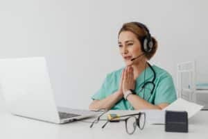 Healthcare professional evaluating patient communication during bilingual new-patient intake quality control.
