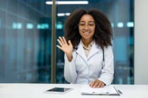 Healthcare professional greeting a patient during after-hours patient message escalation.