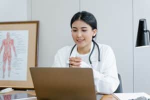 Healthcare professional providing virtual front desk support for after-visit instructions during an online patient consultation.
