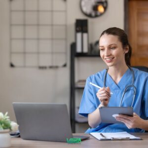 Healthcare professional reviewing digital records to complete referral document readiness checks.