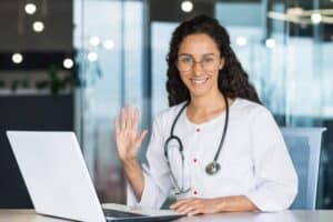 Healthcare professional using a laptop to support pre-visit digital intake cleanup for new patient growth.