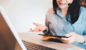 Medical virtual assistant reviewing an urgent caller’s information during an after-hours medical call escalation protocol.