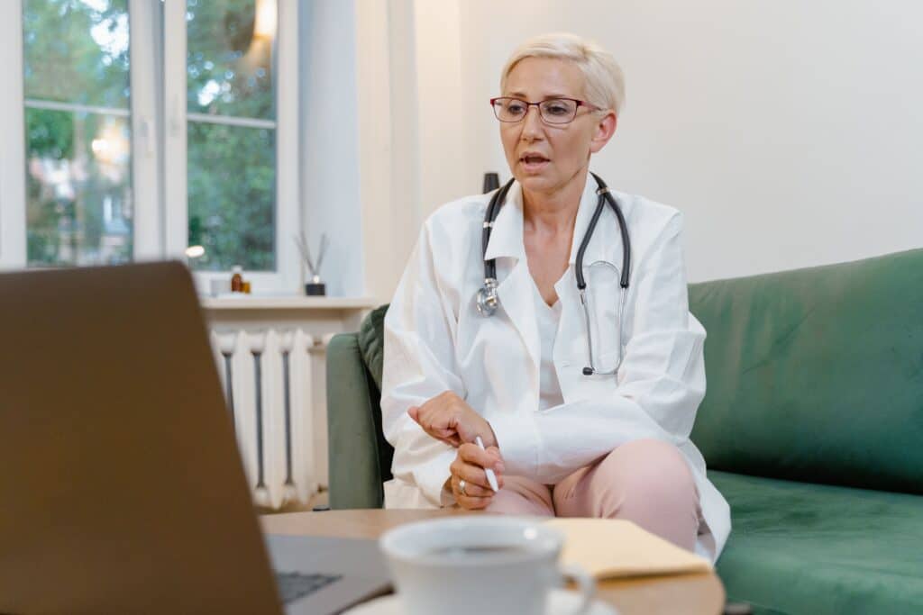 a doctor assisting or discussing with patient through video call